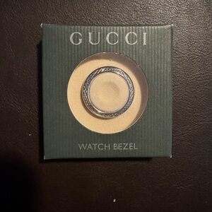 Very rare collectible vintage Gucci diamond watch bezel with silver background.